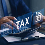 Businessman,Using,The,Laptop,To,Fill,In,The,Income,Tax