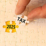 Cream colored puzzle with piece removed showing the word tax and 2025