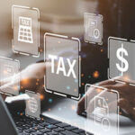 Person typing on a laptop with graphic images overlaid of a dollar sign, the word "Tax" and other symbols representing tax season
