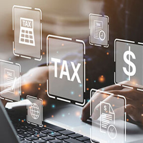 Person typing on a laptop with graphic images overlaid of a dollar sign, the word 