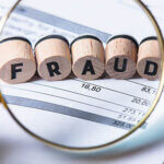 Fraud Blocks Through Magnifying Glass On Invoice