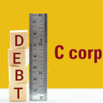 The word "DEBT" spelled out in blocks next to a ruler with "C corp" written next to it