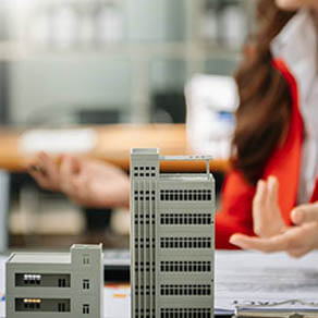 Small Toy House Small Mortgage Property and person's hands explaining something