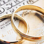 Wedding rings on sitting on top of cash