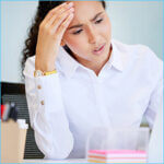 Businesswoman sitting alone in the office and feeling stressed while using her laptop