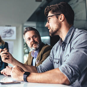 Two men in discussion at a table