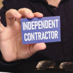 Close up of someone holding a business card reading "Independent Contractor"