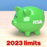 Green piggy bank with the words "HSA" on it and the words 2023 written under it