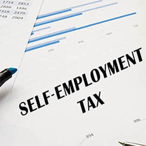 SELF EMPLOYMENT TAX written out on form with highlighter and pen next to it