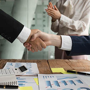 Close up of business people shaking hands, finishing up meeting