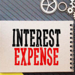 Notebook with "Interest Expense" written on the cover