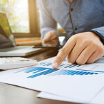 auditor or financial inspector working on sales performance report