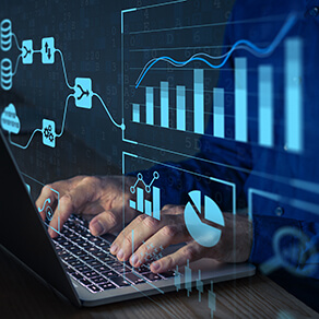 Hands typing on a keyboard in the dark with images of graphs overlaid on the photo