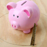 piggy bank with hole being sawed from under neath