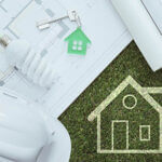 Blueprint with a light blub, keychain, hard hat and simple house image drawn out