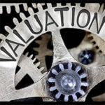 Macro photo of tooth wheel mechanism with VALUATION concept letters