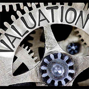 Macro photo of tooth wheel mechanism with VALUATION concept letters