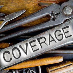 Photo of various tools and instruments with COVERAGE letters imprinted on a clear wrench surface