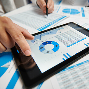 Businessman working and calculating, reads and writes reports. Using tablet pc. Office employee, table closeup. Business financial accounting concept.