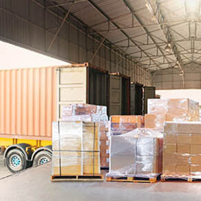 Bulk pallets of packaging boxes being loaded onto a container truck