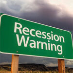 Recession Warning Green Road Sign Over Dramatic Clouds and Sky.