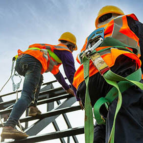 worker with hooks for safety body harness on the roof structure