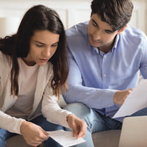 Couple sitting together reviewing documents