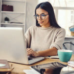 Woman working from a home office on her laptop