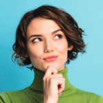 Close up of a women with her hand on her chin as she looks up