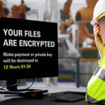 Engineer deflated looking at a screen reading, "Your Files Are Encrypted"