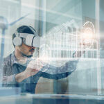 Concept futuristic design. A man Architect or Engineer wearing VR headset for working design 3D architectural building model with BIM technology and virtual reality technology.