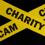 caution and warning concept. Yellow barricade tape with word in dark black background