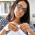 Shot of a woman opening her mail in her office at home