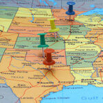 Close up of map of the US with 4 push pins in select states