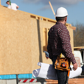 Construction man looking at structure being built