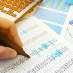 Business audit. Auditor checking documents with financial figures.