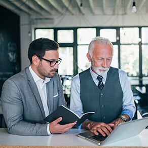 Handsome young and mature business men discussing work.