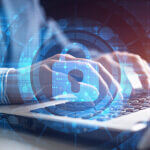 Blue digital lock with person on computer in background