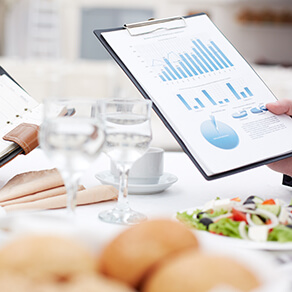 Close-up of open notepad and business document in male hand during business lunch