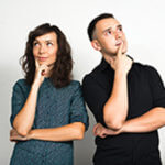 A lady and man standing with their finger on their chin looking up in thought