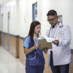 Doctor and assistant looking at papers