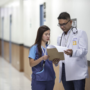 Doctor and assistant looking at papers