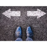 Man shoes with two arrows point in opposite directions on pavement