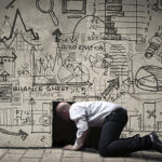 Man looking into hole in sketched wall