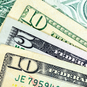 Partial corners of two ten dollar bills, one front view and one back view and a five dollar bill