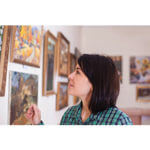 Woman looking at photos on a wall