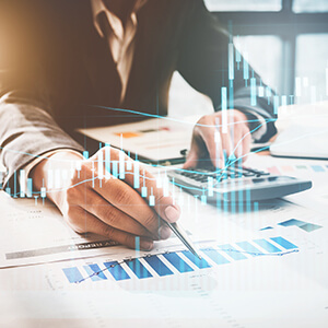 Man working on a graph using a calculator
