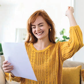 Young woman giving an excited reaction looking at a document