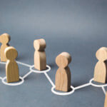 Wooden figures in an off center row