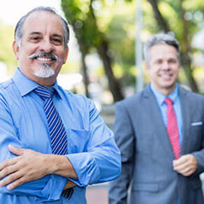 Older businessman colleagues outdoor in city in summer